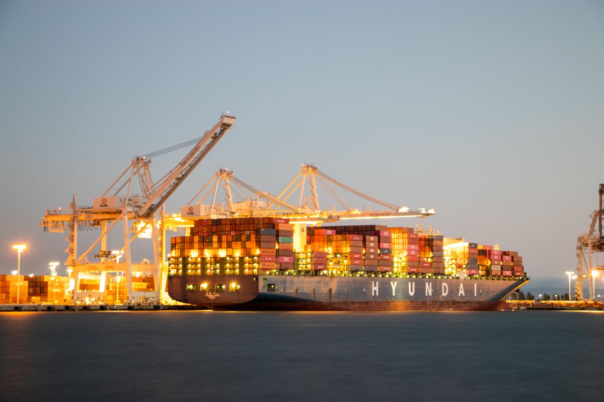 Container ship docked at dusk